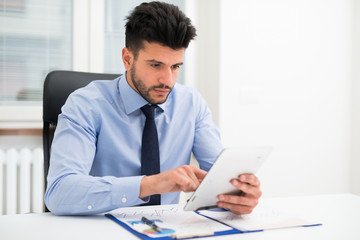 Businessman using a tablet in his office