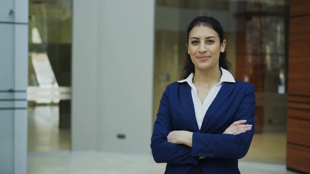 Portrait of successful businesswoman smiling and looking into camera in modern office