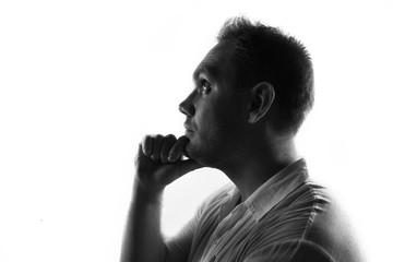 Portrait of thinking man,back lit isolated on white
