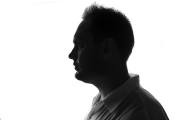 Male person silhouette,back lit over white