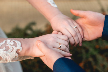 Loving couple holding hands with rings