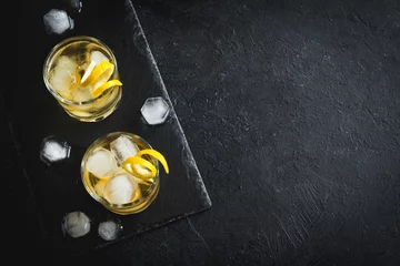 Tuinposter Whiskey on the rocks with lemon © mizina