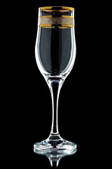 glass of wine with a gold rim  on a black background (isolate).