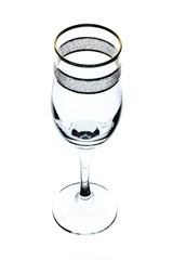 empty glass of wine with gold rim on white background (isolate).