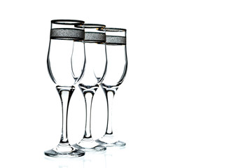 a few empty glasses of wine with a gold rim on a white background (isolate).
