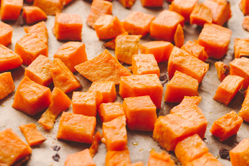 Roasted sweet potato cubes on a baking paper