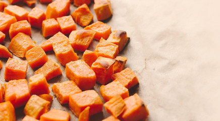 Roasted sweet potato cubes on a baking paper