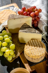 Tasting of oldest french AOC soft pudgent yellow cheese Livarot,  Munster and semifirm Tomme french...