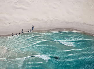 Aerial view of horses trotting on Noordhoek Beach in early morning. Riders are often spotted...