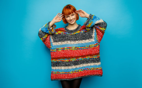 Colorful Photo Of Young Smiling Female Model Wear Oversize Sweater Isolated On Blue Background