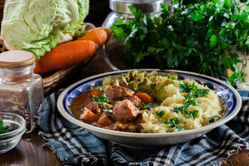 Traditional irish stew served with potatoes and cabbage