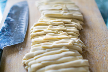 Japanese Udon Noodle on cutting board with sharp knife 