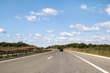 Scenic view on highway road leading through in Istria, Croatia, Europe / Beautiful natural environment, sky and clouds in background / Transport and traffic infrastructure / Road signs and signaling.