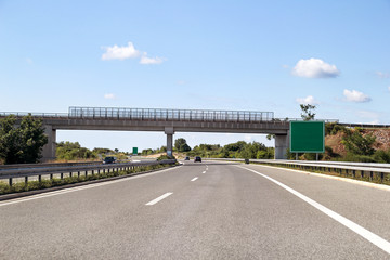 Scenic view on overpass and highway road leading through in Croatia, Europe / Beautiful natural environment, sky and clouds in background / Transport and traffic infrastructure / Signs and signaling.