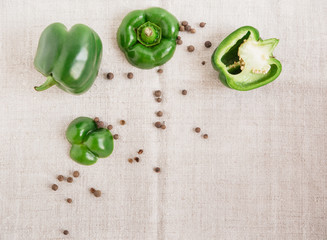Plakat Green sliced bell pepper on the tablecloth.top view.