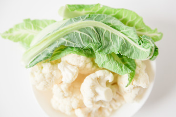fresh cauliflower in white plate.white background.close-up view