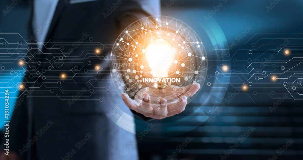 Poster Innovation and technology concept. Businessman holding light bulb with global network connection and word of business on virtual screen interface