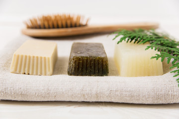 hand made soap with brush and branch on the towel