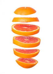 Naklejka na ściany i meble Creative concept with flying orange. Sliced orange isolated on white background. Levity fruit floating in the air.