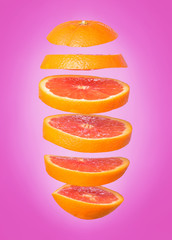 Creative concept with flying orange. Sliced orange isolated on white background. Levity fruit floating in the air.