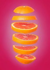 Creative concept with flying orange. Sliced orange isolated on white background. Levity fruit floating in the air.