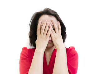 Fototapeta premium brunette girl is bored, dressed in red, isolated on white background