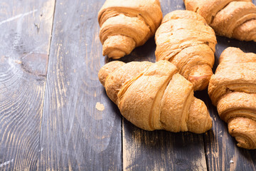 French traditional breakfast croissant on wooden background