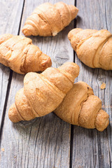 French traditional breakfast croissant on wooden background