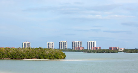 Waterfront condominiums and timeshares on Estero Island, as seen from the New Pass Bridge which connects Fort Myers Beach to Bonita Beach, Florida, USA. 