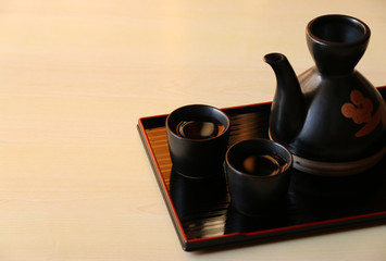Obraz na płótnie Canvas japanese sake on wooden table Copy space