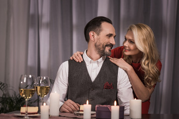 wife hugging husband and they looking at each other