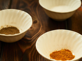 Spices in bowls, salt, pepper, turmeric.