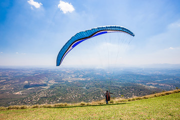 Belo Horizonte, Minas Gerais, Brazil. Paraglider flying from top of the world mountain
