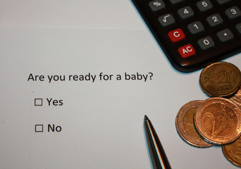 Paper with survey question: Are you ready for a baby? Yes or No box and euro coins and calculator....