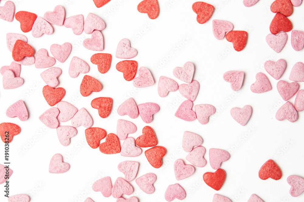 Wall mural close-up view of red and pink sugar hearts forming an abstract background pattern.