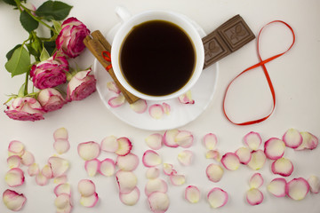 Inscription on the eighth of March from rose petals, coffee, cinnamon, chocolate on a white background