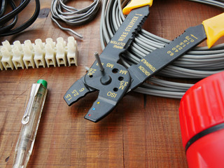 Cutting cable with wire cutter. Vintage hand tools for electrical work DIY repair and installation