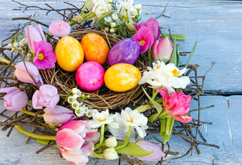 Happy Easter: nest with Easter eggs, feathers, tulips and daffodils:)