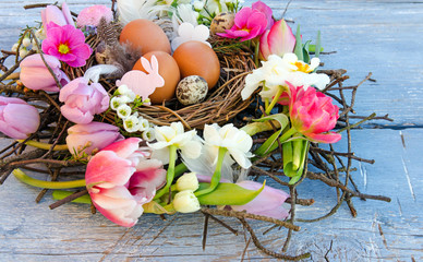 Happy Easter: nest with Easter eggs, feathers, tulips and daffodils:)