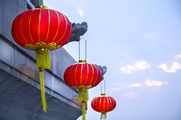Chinese red lanterns in a Thai-Chinese temple on light sky background as an up-coming Chinese new year celebrate decoration with side blank copy space.