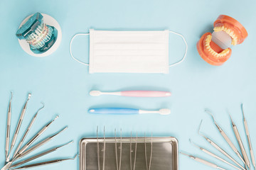 dentist tools and orthodontic on color background, flat lay, top vipw.