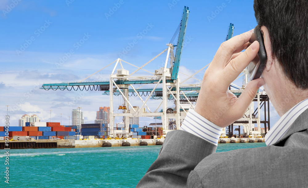Aufkleber businessman use smart phone for logistic business, in the background container terminal with cranes