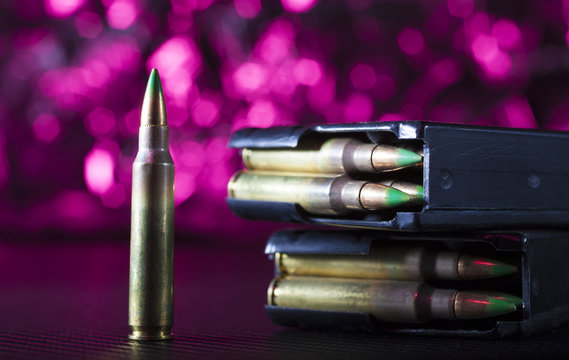 AR-15 magazines and ammo with a purple background