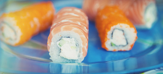 sushi rolls close up on a blue background