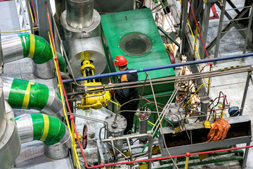 Mechanical engineer rotates control valve and adjusting compressor system 