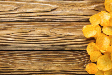 Potato Chips on old wooden table, detailed close-up, fastfood concept