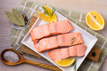 Boiled salmon on white plate. Poached salmon fillet. Good for health diet fish. View from above,...