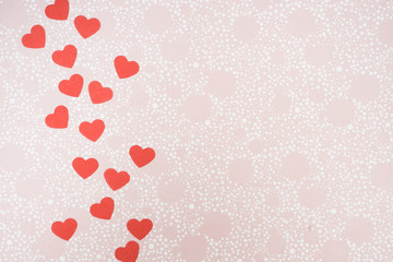 Decoration for Valentine's Day: hole puncher made paper shapes of red hearts