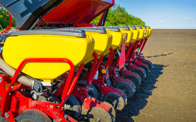 Close-up of a plow for a tractor standing on an agricultural field.
