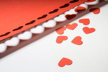 Decoration for Valentine's Day: hole puncher made paper shapes of red hearts